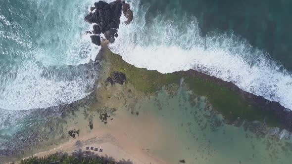 Ocean Waves with White Foam Roll on Yellow Sandy Beach