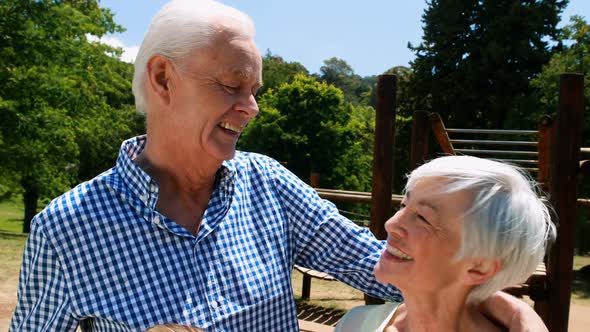 Senior couple interacting with each other in park