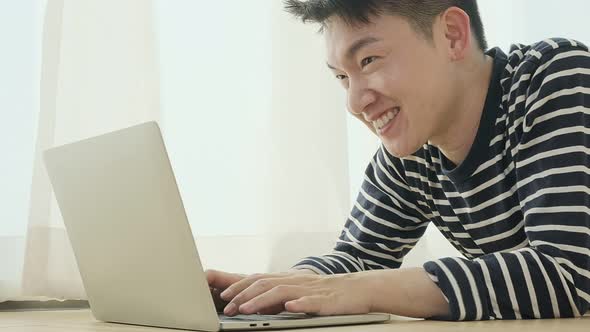 happiness peaceful smile asian male enjoy work from home quarantine  relax and positive work