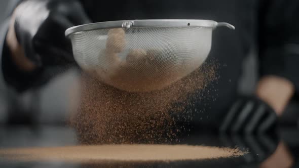 Chef Confectioner Sifts Cocoa Truffles in Sieve in Slow Motion, Professional Chocolatier Makes