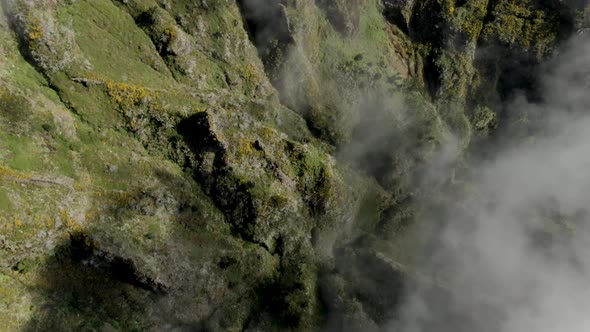 Aerial view of the mountains and the clouds at Pico Ruvio in Madeira, Portugal.