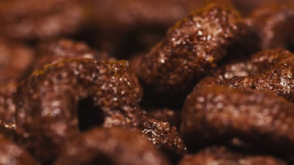 Chocolate Breakfast Cereal in Black Plate, Morning Food in Slow Motion.