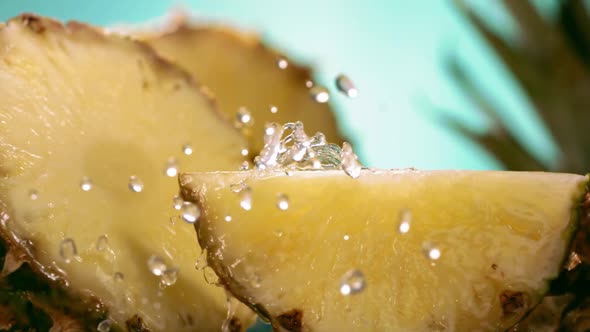 Slow Motion Shot of Pineapple and Water Splashing Through Pineapple Slices