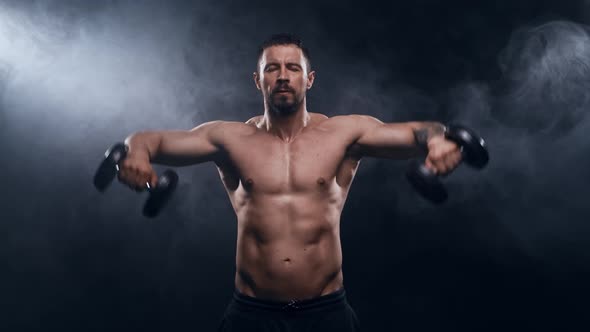 Fit and sporty bodybuilder over black background.