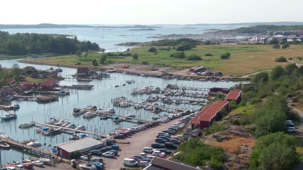 Beautiful pier with many boats surrounded by green landscape, aerial view