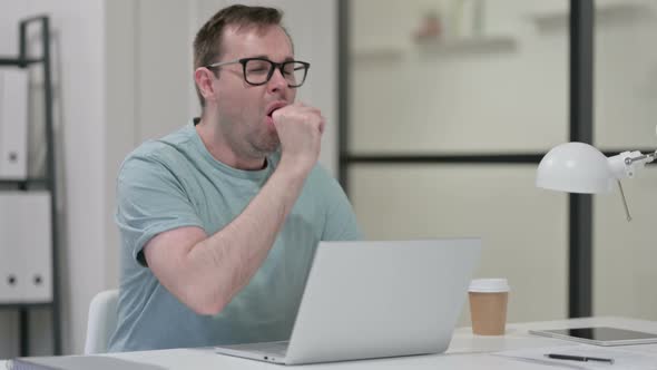 Young Man Having Coughing While Working Laptop