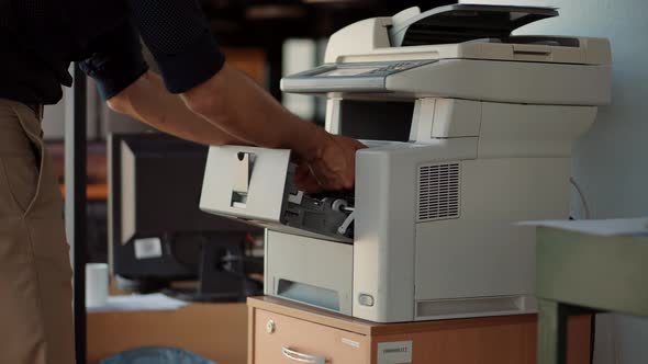 Man Using Printer Or Scanner In Office. Businessman Printing Document On Workplace. Copier.