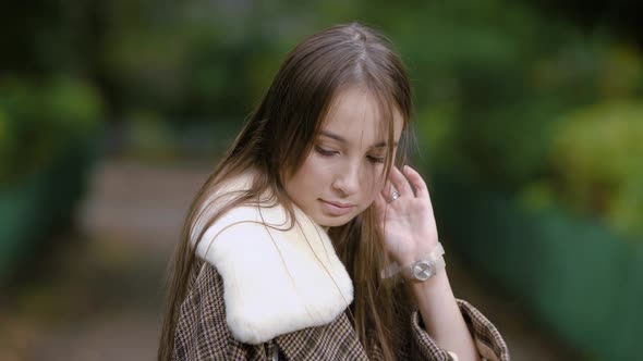 Portrait of Charming Brunette Girl in a Checkered Fall Coat Outside, Cold Weather