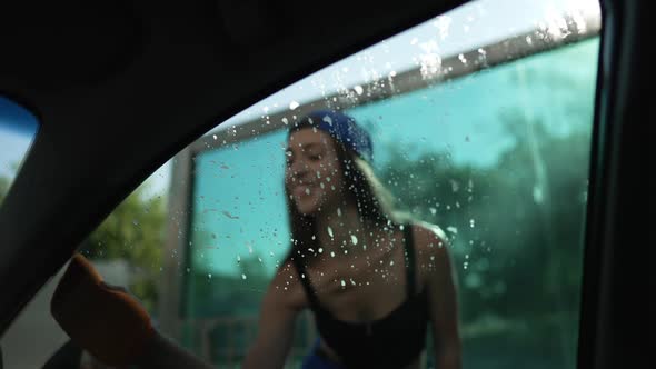 Female Hand Cleaning Car Side Window with Cloth in Slow Motion