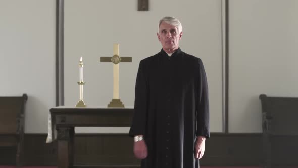 Preacher checking his watch at the front of a church.