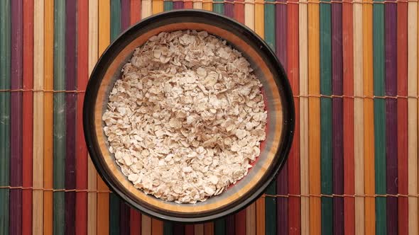 Uncooked Oats Flakes on Table, Top Down 