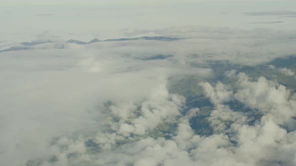 Aerial view from plane, clouds and mountains