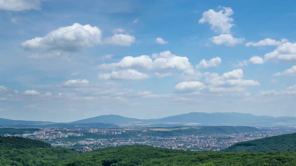 White Clouds in Blue Sky over Big City