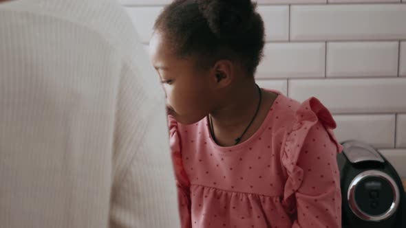 Concentrated little girl eating breakfast alt