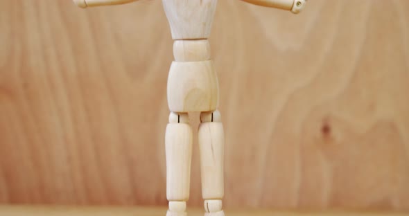 Figurine standing with arms stretched