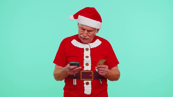 Mature Christmas Grandfather Man Use Mobile Cell Phone Plastic Credit Bank Card Win Calebrate Wow