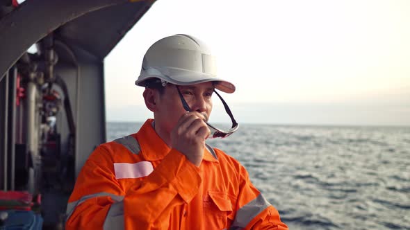 Filipino Deck Officer on Deck of Offshore Vessel or Ship Fills Checklist. Paperwork at Sea