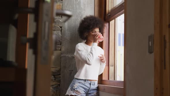 Mixed race woman drinking coffee