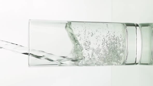 Vertical Video Crystal Clear Water Pouring Into Glass