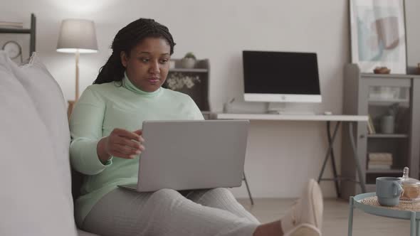 African-American Businesswoman Staring Working on Laptop