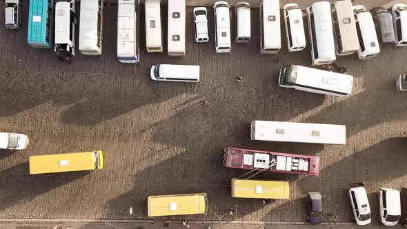 Aerial footage of many cars and buses moving on a busy city street.