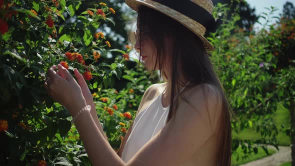 Girl Smelling Flowers in the Park