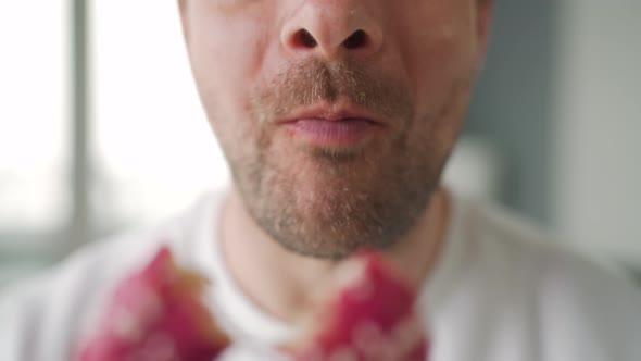 Man Eating Sweet Pink Donut