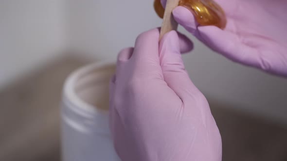 Cropped View of Process of Taking Wax for Beautician Procedure