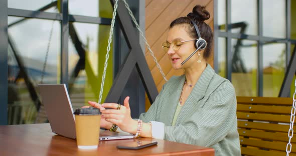 40 Years Old Woman During an Online Video Call in Outdoor Cafe