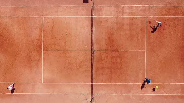 Overhead Shot of a Tennis Player Who Stands and Hits the Ball During a Sports Practice on an Outdoor