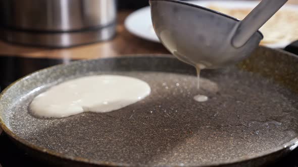 Unrecognizable Woman Pours Screed Dough Into a Hot Frying Pan