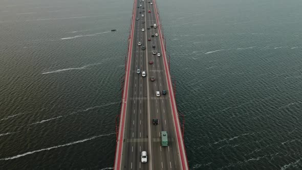 Aerial Top View Of Vehicles On Bridge Over River At Cloudy Day Drone Flying Forward Over Cars Dnipro