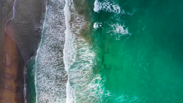 Aerial View of the Mediterranean Coast Waves Reach the Deserted Sandy Beach