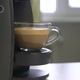 Female hand taking out prepared coffee with milk from coffee machine. - VideoHive Item for Sale
