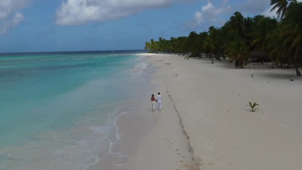 Happy Couple in Love is Walking on a Tropical Beach Vacation Dominican Republic