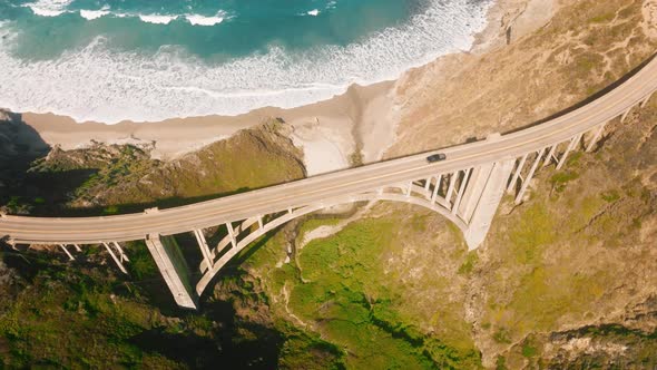 Top Down Car Driving By Scenic Arch Architecture Bixby Bridge Above Blue Ocean