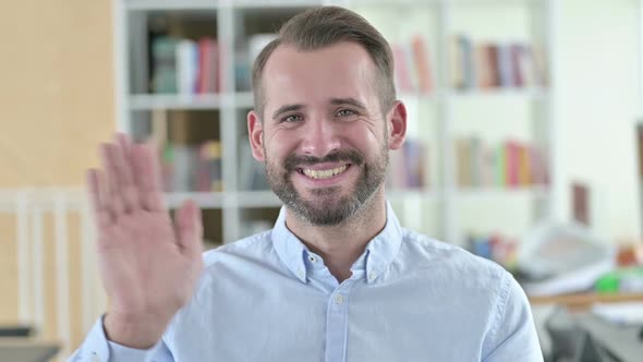 Portrait of Cheerful Young Man Waving