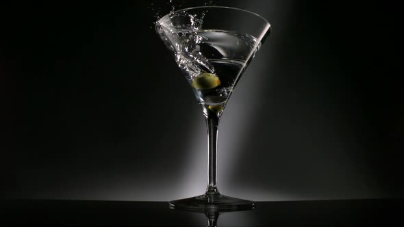 Olive dropped into martini glass, Slow Motion