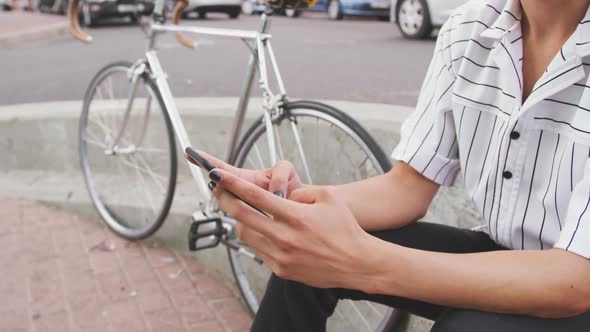 Mixed race man using his phone outside