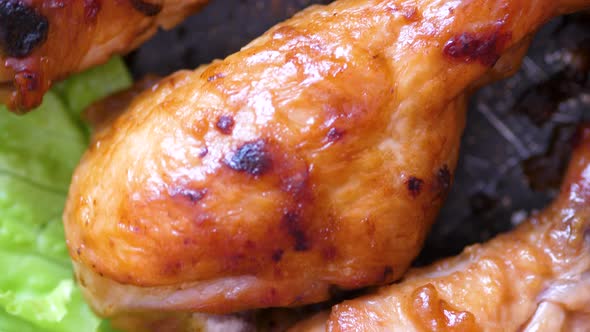 close-up fried chicken legs with appetizing crispy crust rotate. Grilled chicken dish. Chicken with 