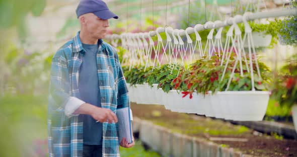 Cheerful Farmer Spraying Herbicide at Farm