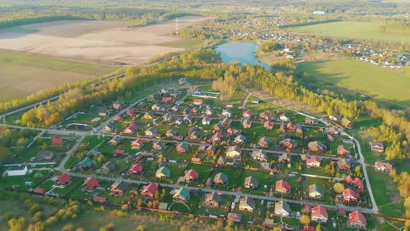 Small Cottage Village with Cute Houses Between Asphalt Roads