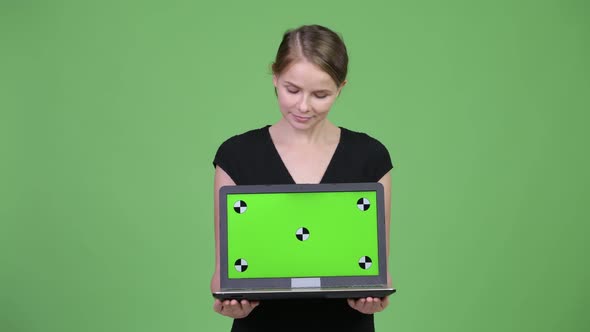 Young Happy Businesswoman Showing Laptop