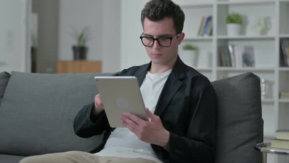 Young Male Designer Using Tablet at Home 