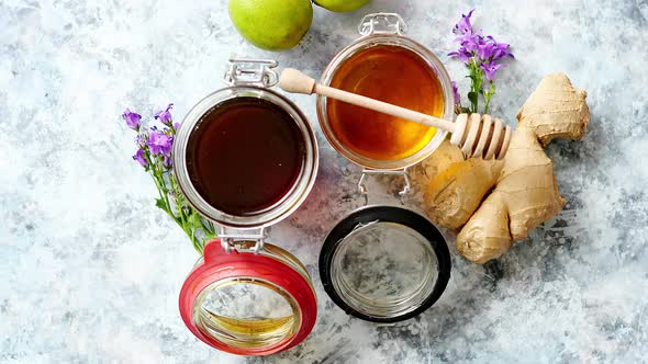 Healthy Food Table with Different Kinds of Honey, Fresh Ginger and Lime