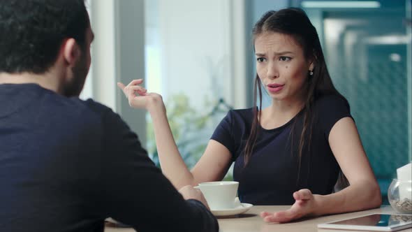 Young Couple Having an Argument at the Cafe