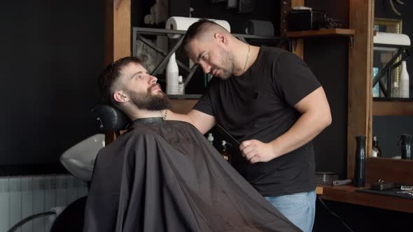 Barber Trimming Beard of Client