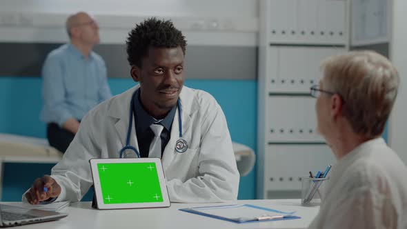 Young Doctor with Green Screen Technology on Tablet