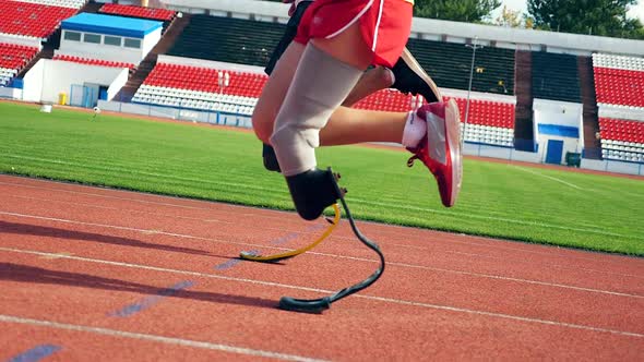 Close Up of Artificial and Healthy Legs of Athletes While Running