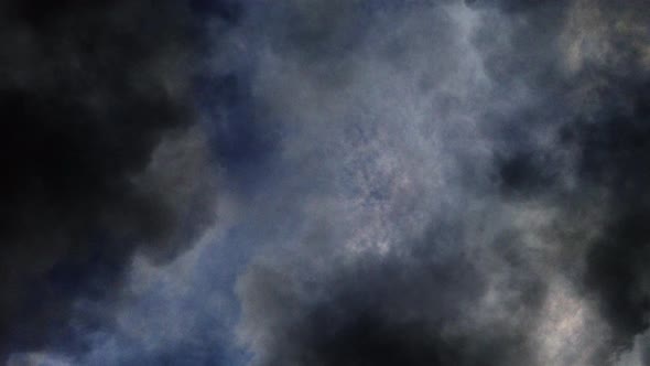 4k point of view, blue sky with dark clouds around it and storms